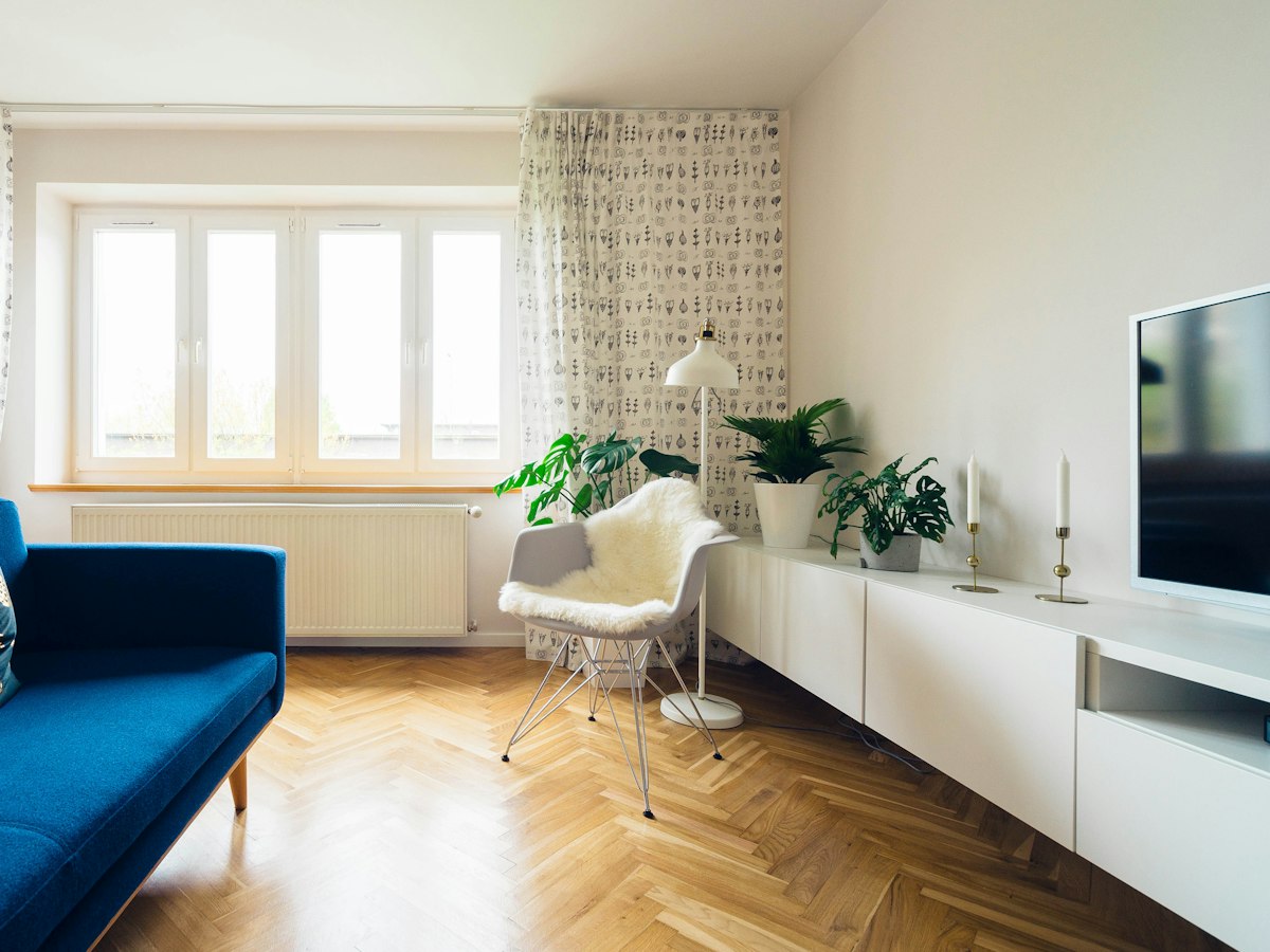 Modern living room with large white-framed windows and daylight